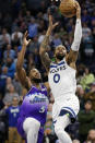 Minnesota Timberwolves guard D'Angelo Russell (0) shoots over Utah Jazz guard Malik Beasley (5) in the third quarter during an NBA basketball game Monday, Jan. 16, 2023, in Minneapolis. (AP Photo/Andy Clayton-King)