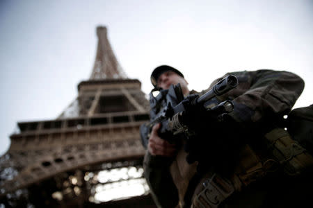 FILE PHOTO: A French soldier stands guard under the Eiffel Tower, as France officially ended a state of emergency regime, replacing it with the introduction of a new security law, in Paris, France, November 1, 2017. REUTERS/Christian Hartmann