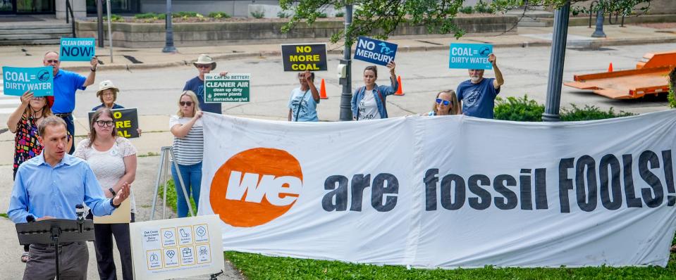 State Sen. Chris Larson, left, discusses the effects of We Energies extending the life of the power plant in Oak Creek during a protest against the utility's plans to delay the closure of the plant.