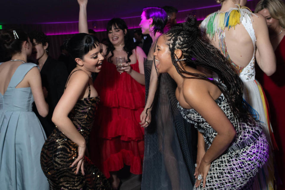 Alexa Demie and Taylor Russell dancing at the 2020 Vanity Fair Oscar Party