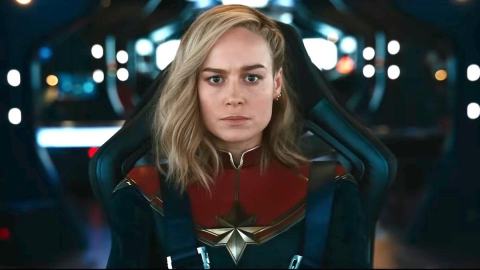 Carol Danvers looks pensive while sitting in the cockpit of her spaceship in The Marvels