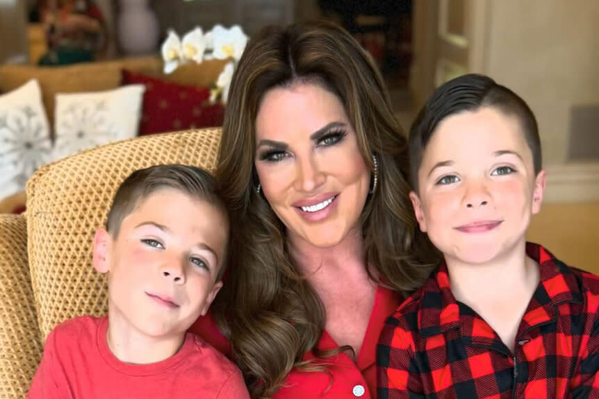 Emily Simpson smiling with her twin sons, Luke and Keller Simpson.