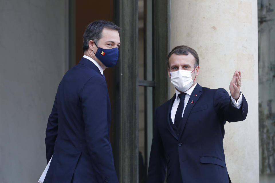 French President Emmanuel Macron, right, welcomes Belgium's Prime Minister Alexander De Croo, prior to a meeting, at the Elysee Palace, in Paris, France, Tuesday, Dec. 1, 2020. (AP Photo/Thibault Camus)