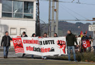 Rail workers of CGT union hold a banner that reads: "Railworkers in Struggle" as they demonstrate in Hendaye, southwestern France, Friday, Dec. 6, 2019. Frustrated travelers are meeting transportation chaos around France for a second day, as unions dig in for what they hope is a protracted strike against government plans to redesign the national retirement system. (AP Photo/Bob Edme)