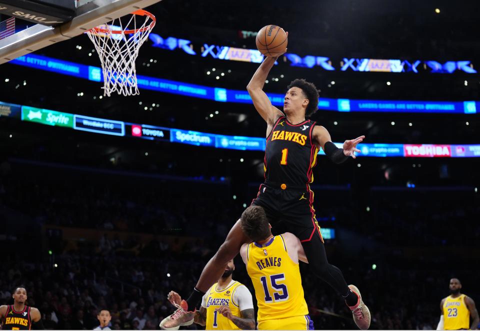 Atlanta Hawks forward Jalen Johnson (1) dunks the ball over Los Angeles Lakers guard Austin Reaves (15) in the first half at Crypto.com Arena on March 18, 2024, in Los Angeles, California.
