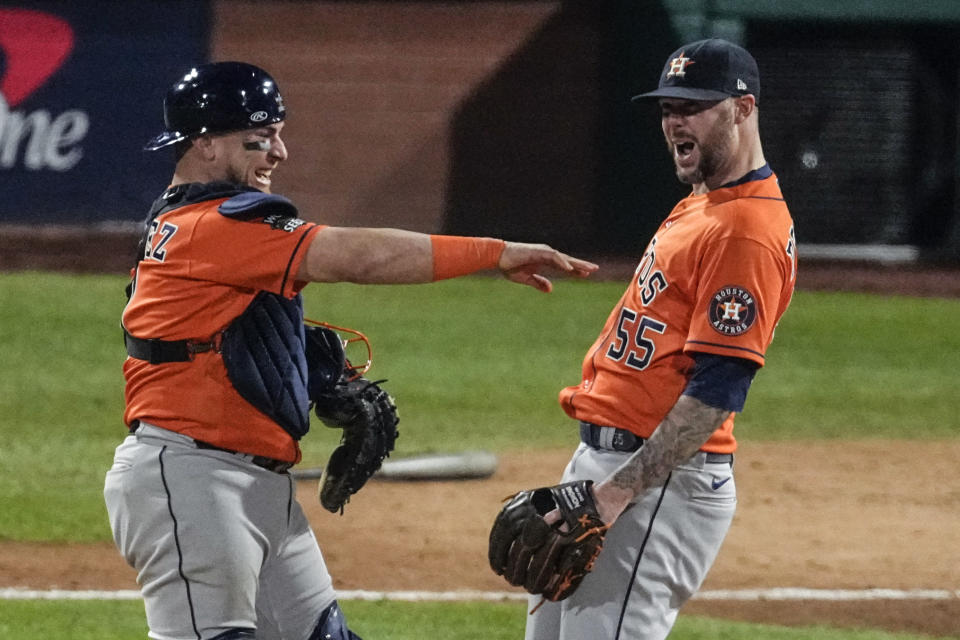 Houston Astros relief pitcher Ryan Pressly and catcher Christian Vazquez celebrate the Astros' win in Game 4 of baseball's World Series between the Houston Astros and the Philadelphia Phillies on Wednesday, Nov. 2, 2022, in Philadelphia. The Astros won 5-0 with a combined no-hitter to tie the series two games all. (AP Photo/Matt Rourke)