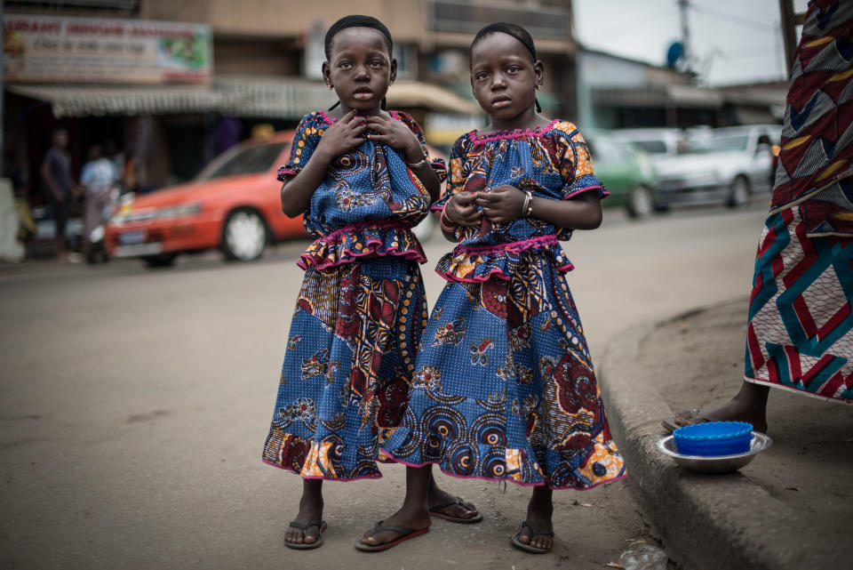 Rasidatou and Latifatou, 4, pose for a portrait on a street in the Koumassi district of Abidjan, Ivory Coast, on July 25, 2017.