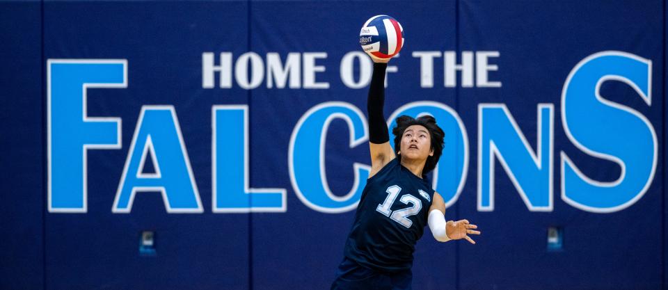 Perry Meridian High School senior Van Awma (12) serves during a varsity volleyball match against Roncalli High School, Wednesday, May 4, 2022, at Perry Meridian High School.