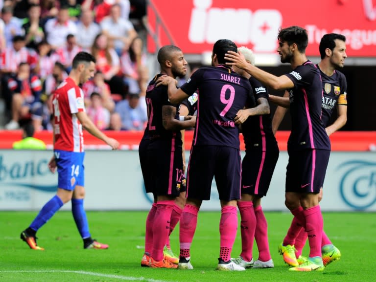 Barcelona's midfielder Rafael Alcantara (2nd L) is congratulated by teammates after scoring a goal against Real Sporting de Gijon during a Spanish league football match at El Molinon stadium in Gijon on September 24, 2016