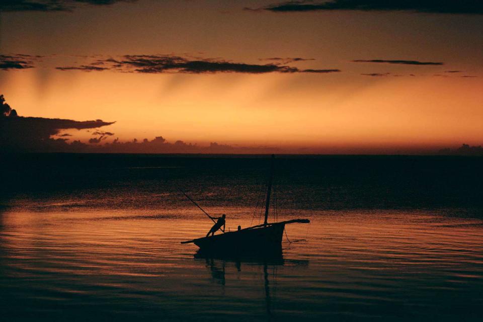 <p>Michael Turek</p> A fisherman steers his boat toward shore near andBeyond Benguerra Island, in Mozambique.