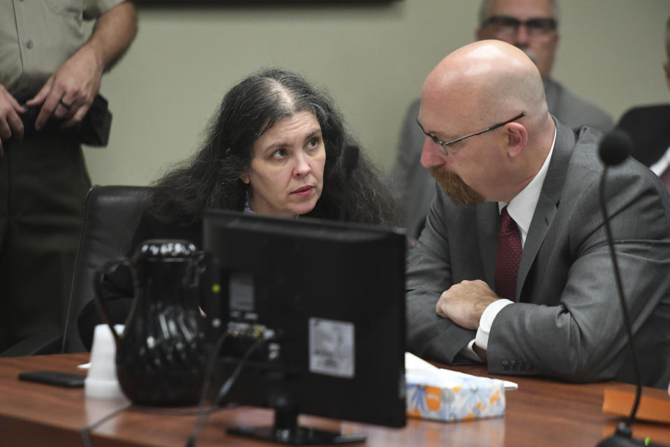 Louise Turpin, left, listens to her attorney, Jeff Moore, during a sentencing hearing Friday, April 19, 2019, in Riverside, Calif. Turpin and her husband, David, who pleaded guilty to years of torture and abuse of 12 of their 13 children have been sentenced to life in prison with possibility of parole after 25 years. (Will Lester/The Orange County Register via AP, Pool)