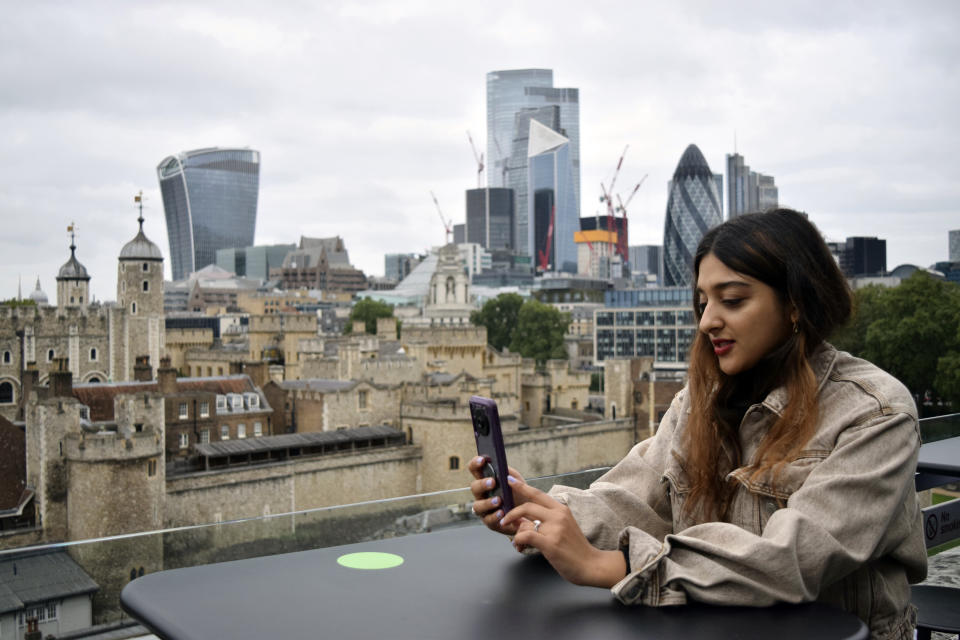 Sonya Barlow, CEO of Like Minded Females Network, takes a call at WeWork, a co-operative work space in London, Thursday, Sep. 2, 2021. Many young workers around the world have entered the workforce and begun their careers during the pandemic working entirely remotely. Like Minded Females Network is a social enterprise that helps young women set up businesses and other ventures, without the use of a fixed office space. (AP Photo/Urooba Jamal)