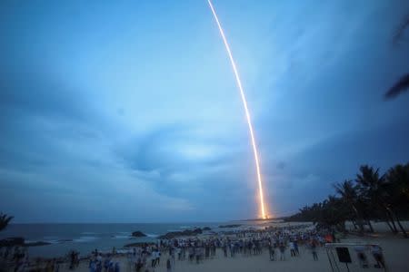 People watch the launch of the Long March-5 Y2 rocket from Wenchang Satellite Launch Center in Wenchang, Hainan Province, China, July 2, 2017. REUTERS/Stringer