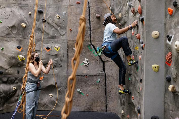 Adrian Wilson, a student at Florida A&amp;M University, climbs the rock wall located in the Hansel Tookes Student Recreation Center on Tuesday, March 29, 2022.