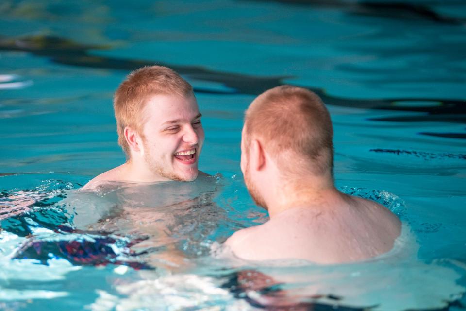 Josh Trollinger, left, was all smiles while swimming with his older brother Chris Trollinger during a new sensory swim program for people with disabilities at the Pueblo Regional Center pool on Friday, Jan. 13, 2023.
