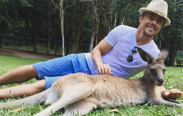 Derek poses with a kangaroo. Photo: Instagram.