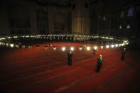 Few face masked people allowed to offer the Eid al-Fitr prayer amid concerns of the coronavirus outbreak at historical Suleymaniye Mosque, in Istanbul, early Sunday, May 24, 2020. Muslims in the world are marking a muted and gloomy religious festival of Eid al-Fitr, the end of the fasting month of Ramadan - a usually joyous three-day celebration that has been significantly toned down due to the new coronavirus outbreak. (AP Photo/Emrah Gurel)