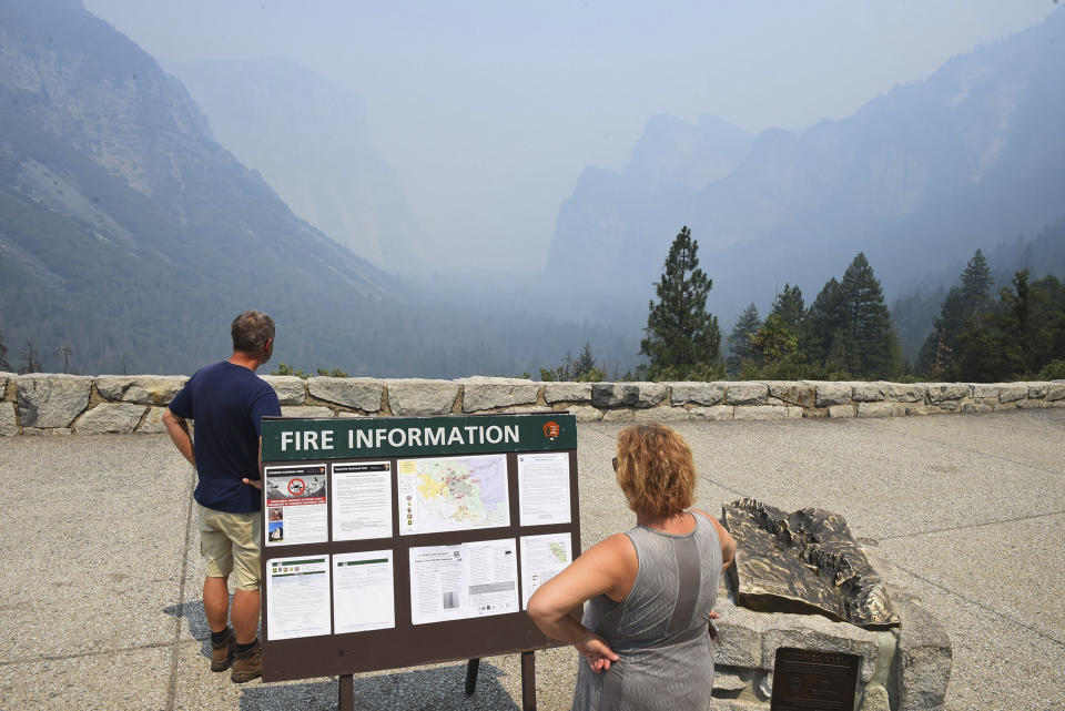 Smoke from the Ferguson Fire fills Yosemite Valley as seen from Tunnel View Tuesday, July 24, 2018, in Yosemite National Park, Calif. A Yosemite National Park official says at least a thousand campground and hotel reservations will be canceled after authorities decided to close Yosemite Valley to keep a growing forest fire at bay. Spokesman Scott Gediman says the valley, the heart of the visitor experience at the park, along with a windy, mountainous, 20-mile (32-kilometer) stretch of State Route 41 that is part of Yosemite will close beginning Wednesday at noon. (Eric Paul Zamora/The Fresno Bee via AP)