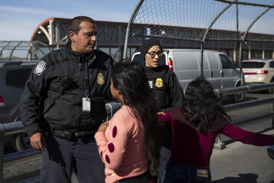 Customs and Border Patrol agents stop a woman and her daughter at the International Boundary Line of the Paso del Norte Port of Entry between Juarez and El Paso on Nov. 28, 2018. The mother did not verbally declare asylum to the agents before a private security officer explained they sign up to be put on “the list” for entry to ask for asylum. (Photo: Adria Malcolm for Yahoo News)