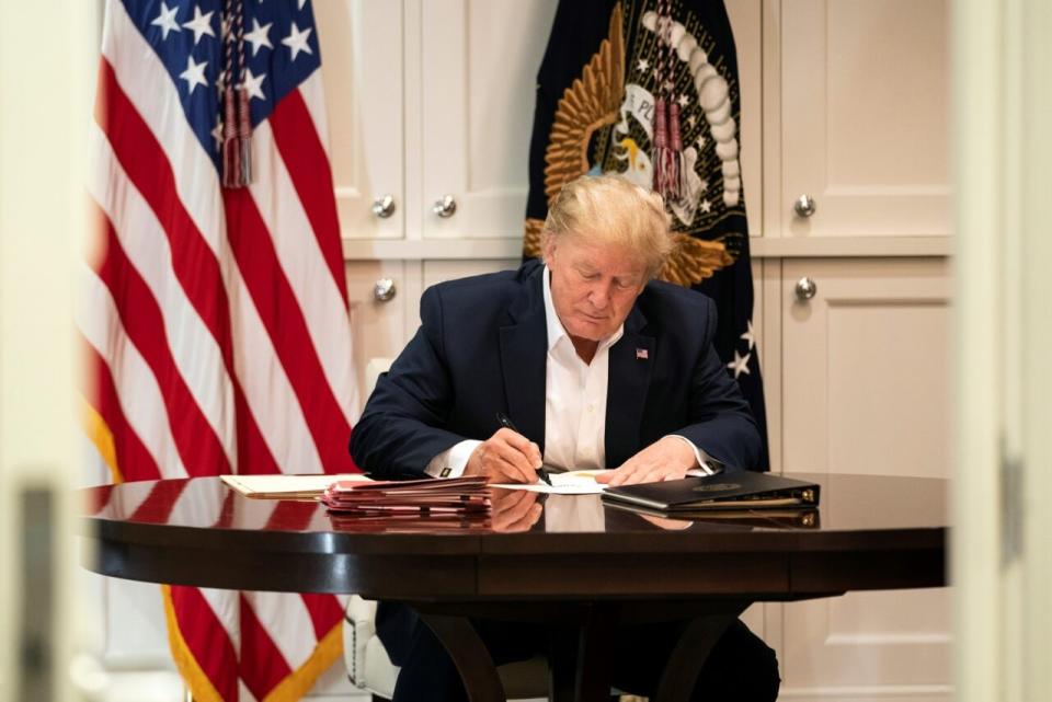 In this handout provided by The White House, President Donald J. Trump works in the Presidential Suite at Walter Reed National Military Medical Center after testing positive for COVID-19 on October 3, 2020 in Bethesda, Maryland. (Photo by Joyce N. Boghosian/The White House via Getty Images)