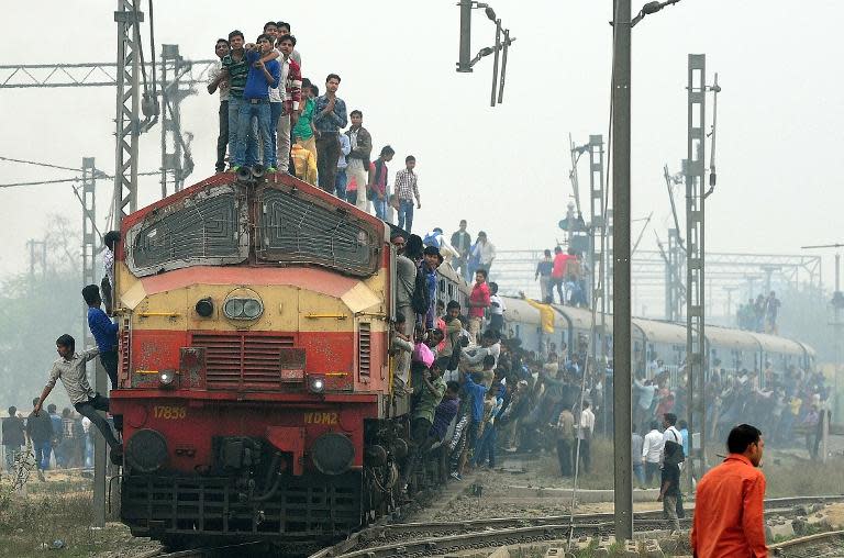 A train departs from a station on the outskirts of New Delhi on February 25, 2015