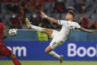 Italy's Ciro Immobile kicks the ball during a Euro 2020 soccer championship quarterfinal match between Belgium and Italy at the Allianz Arena in Munich, Germany, Friday, July 2, 2021. (Andreas Gebert/Pool Photo via AP)