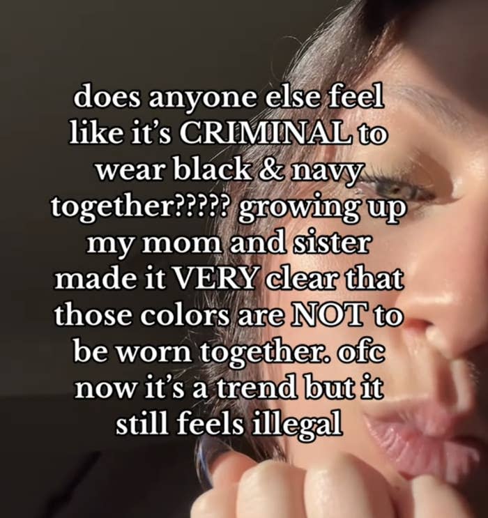 Close-up of a person's face with text overlay that questions the trend of wearing black and navy together