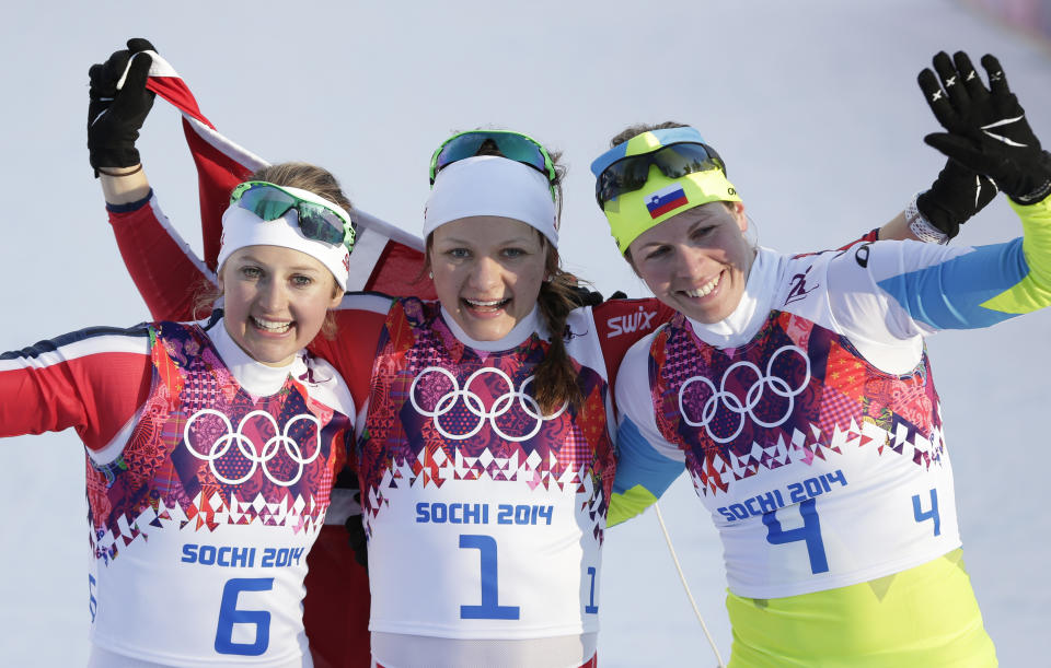 Norway's gold medal winner Maiken Caspersen Falla is flanked by silver medal winner Ingvild Flugstad Oestberg from Norway, left, and Slovenia's bronze medal winner Vesna Fabjan after the women's cross-country sprint the 2014 Winter Olympics, Tuesday, Feb. 11, 2014, in Krasnaya Polyana, Russia. (AP Photo/Matthias Schrader)