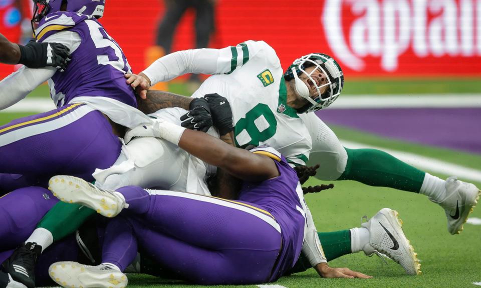 <span>Aaron Rodgers is sacked and twists his knee during the match.</span><span>Photograph: Tom Jenkins/The Guardian</span>