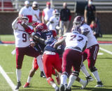 Massachusetts quarterback Garrett Dzuro (9) makes a pass under pressure during the first half of an NCAA college football game against Liberty on Friday, Nov. 27, 2020, at Williams Stadium in Lynchburg, Va. (AP Photo/Shaban Athuman)