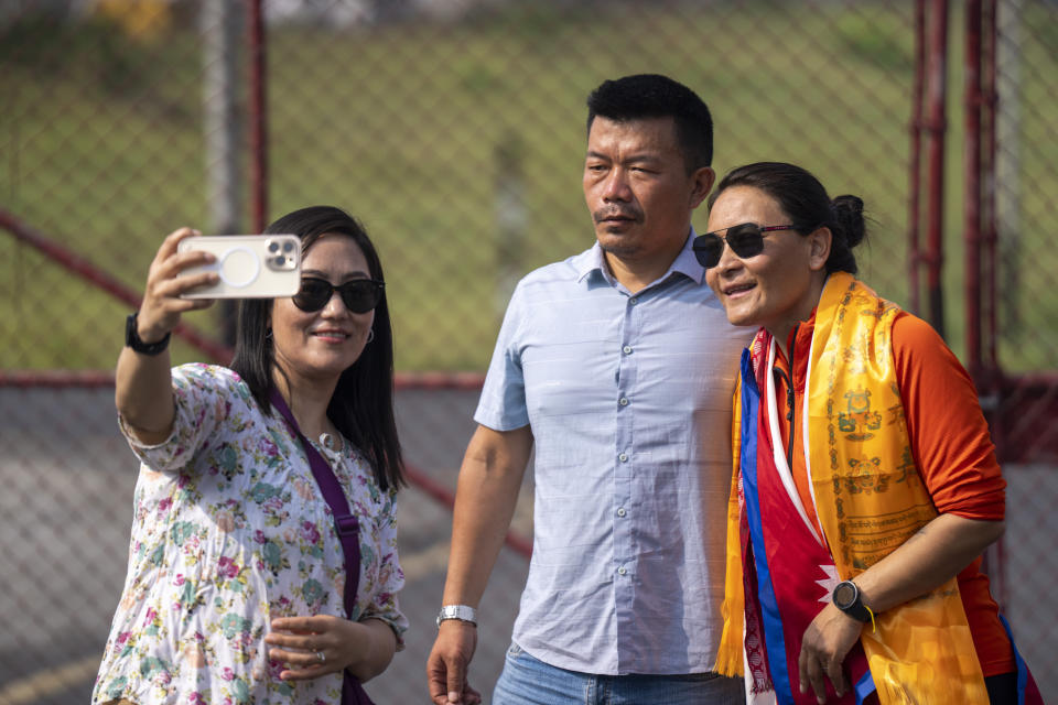 A couple takes selfie with Phunjo Lama, right, on her arrivals at airport in Kathmandu, Nepal, Sunday, May 26, 2024. Lama scaled the peak in 14.5 hours becoming the fastest female to do so. (AP Photo/Niranjan Shrestha)