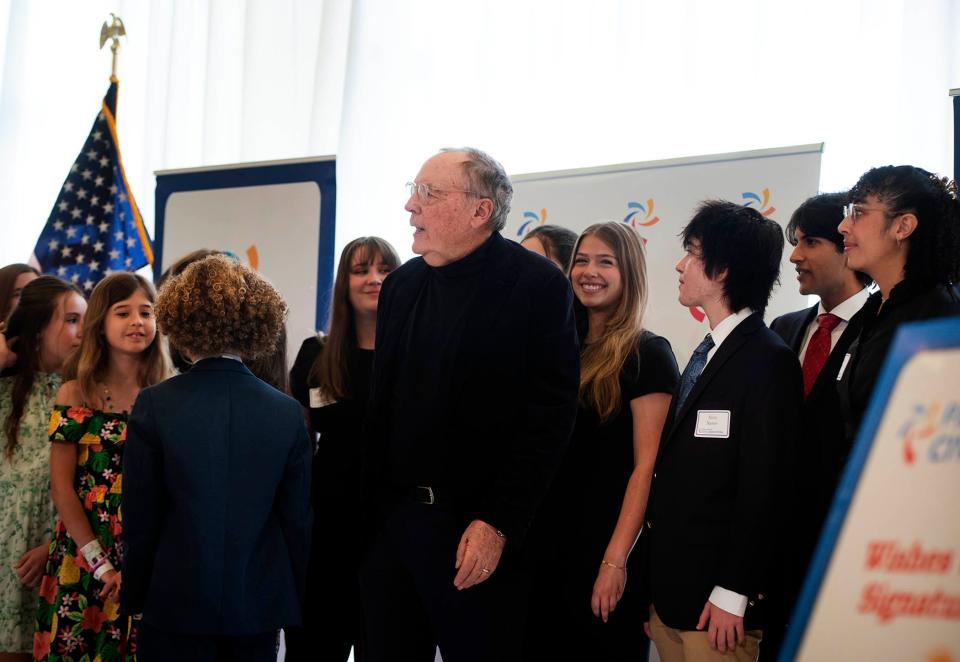 James Patterson poses for a photo with students from Palm Beach Public Elementary, Dreyfoos School of the Arts and Palm Beach Atlantic University during the Palm Beach Civic Association's annual awards breakfast at The Breakers on Wednesday.