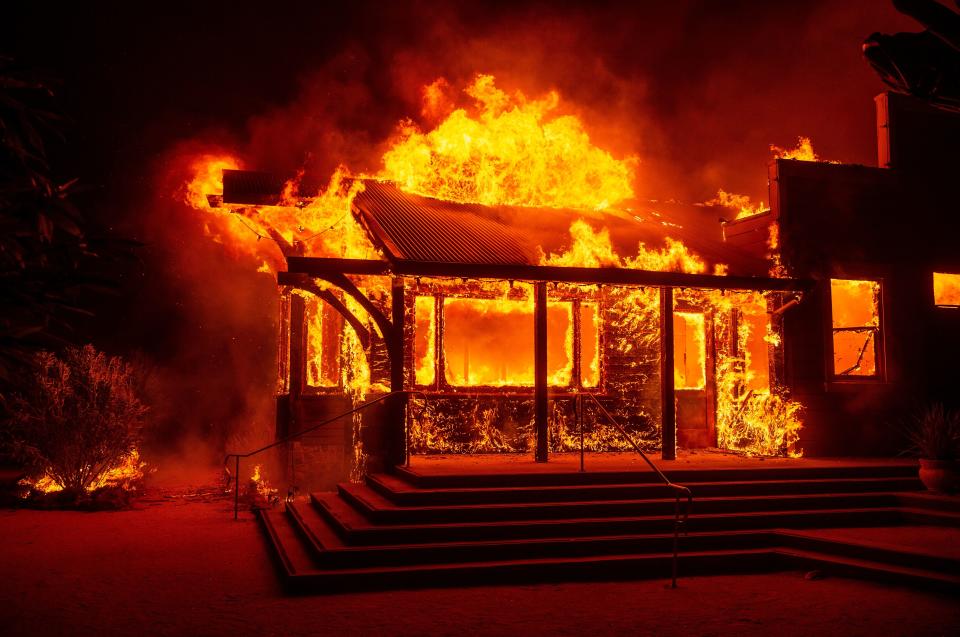 The Soda Rock Winery burns during the Kincade fire as flames race through Healdsburg, California on October 27, 2019. - Powerful winds were fanning wildfires in northern California in "potentially historic fire" conditions, authorities said October 27, as tens of thousands of people were ordered to evacuate and sweeping power cuts began in the US state. (Photo by Josh Edelson / AFP) (Photo by JOSH EDELSON/AFP via Getty Images)