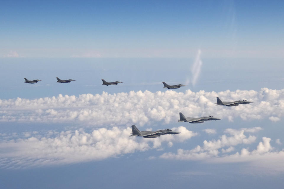 FILE - In this photo provided by the Joint Staff of the Japanese Self-Defense Force, three F-15 warplanes of the Japanese Self-Defense Force, front, and four F-16 fighters of the U.S. Armed Forces fly over the Sea of Japan on May 25, 2022. In a major break from its strictly self-defense-only postwar principle, Japan adopted a national security strategy Friday, Dec. 16, 2022, declaring plans to possess preemptive strike capability and cruise missiles within years to give itself more offensive footing against threats from neighboring China and North Korea. (Joint Staff of the Japanese Self-Defense Force via AP, File)