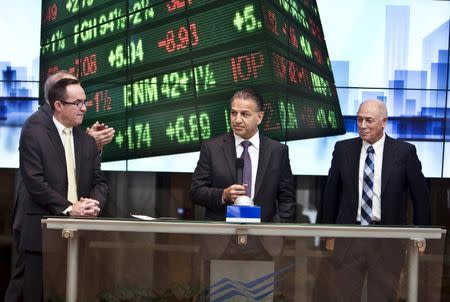 Robert J. Coury, Chairman and Chief Executive Officer of Mylan (C) stands next to Amnon Neubach, the chairman of Tel Aviv Stock Exchange (R) during a bell ringing ceremony at the Tel Aviv Stock Exchange, Israel November 4, 2015. REUTERS/Nir Elias