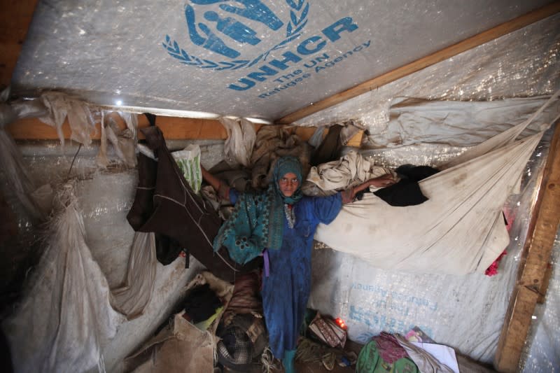 Girl is pictured inside her family's hut at a camp for internally displaced people in Khamir of the northwestern province of Amran