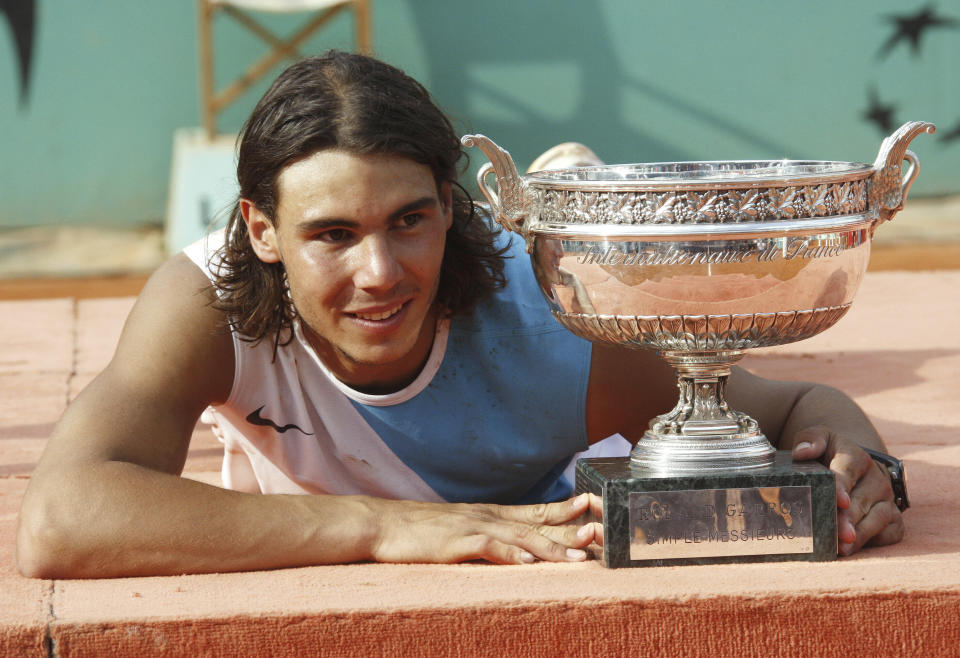 FILE - Spain's Rafael Nadal poses with the cup after defeating Switzerland's Roger Federer during the men's final match of the French Open tennis tournament at Roland Garros stadium in Paris, Sunday, June 10, 2007. Nadal won 6-3, 4-6, 6-3, 6-4. (AP Photo/Michel Spingler, File)