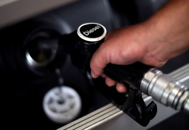 A man fuels his car at a petrol station in London