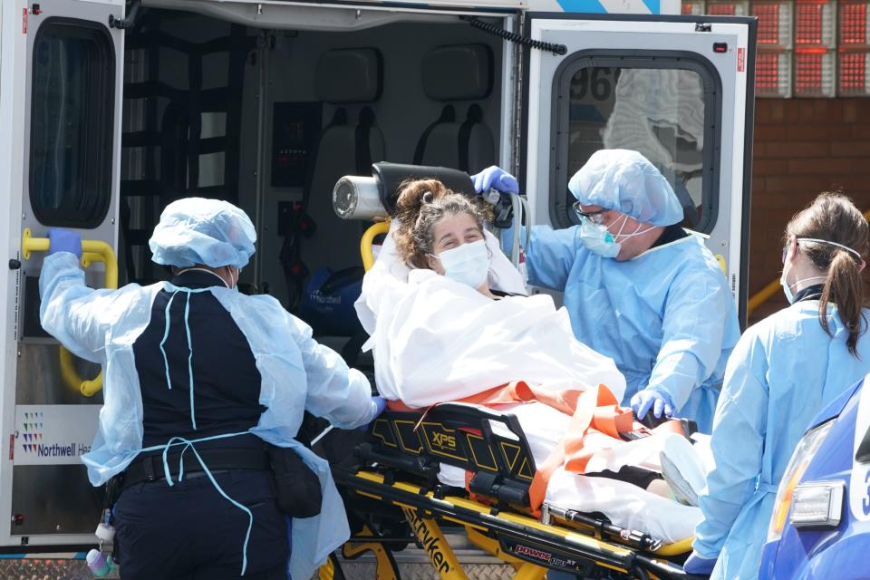 A woman arrives by ambulance to Wyckoff Hospital in the Bushwick section of Brooklyn April 5, 2020 in New York. Governor Andrew Cuomo reported that the coronavirus death toll in New York state spiked to 4,159, up from 3,565 a day prior. (Bryan R. Smith / AFP/Getty Images)