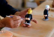 A worker paints a U.S. President Trump "caganer", in a pottery in Torroella de Montgri