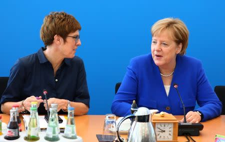 German Chancellor Angela Merkel talks to secretary general Annegret Kramp-Karrenbauer before a Christian Democratic Union (CDU) leadership meeting in Berlin, Germany, July 2, 2018. REUTERS/Hannibal Hanschke