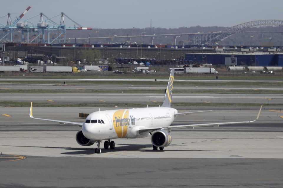 A charter jet for Primera Air taxis at Newark Liberty International Airport, Wednesday, May 2, 2018, in Newark, N.J. (AP Photo/Julio Cortez)