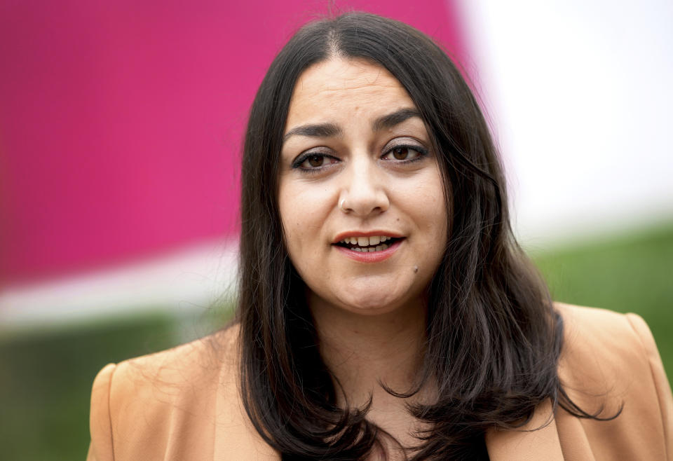 Ezgi Guyildar, the 35-year-old daughter of Kurdish refugees from Turkey, candidate of the German Left Party (Die Linke) for the upcoming parliament elections, smiles during an interview with the Associated Press in Berlin, Germany, Sunday, Sept. 19, 2021. Hundreds of immigrants are running in Germany's national election on Sunday, raising the possibility of making its next parliament more diverse than ever. While it still might not fully represent the country's overall diversity, where more than a quarter of the population has immigrant roots, it's a step toward a more accurate reflection of society. (AP Photo/Michael Sohn)