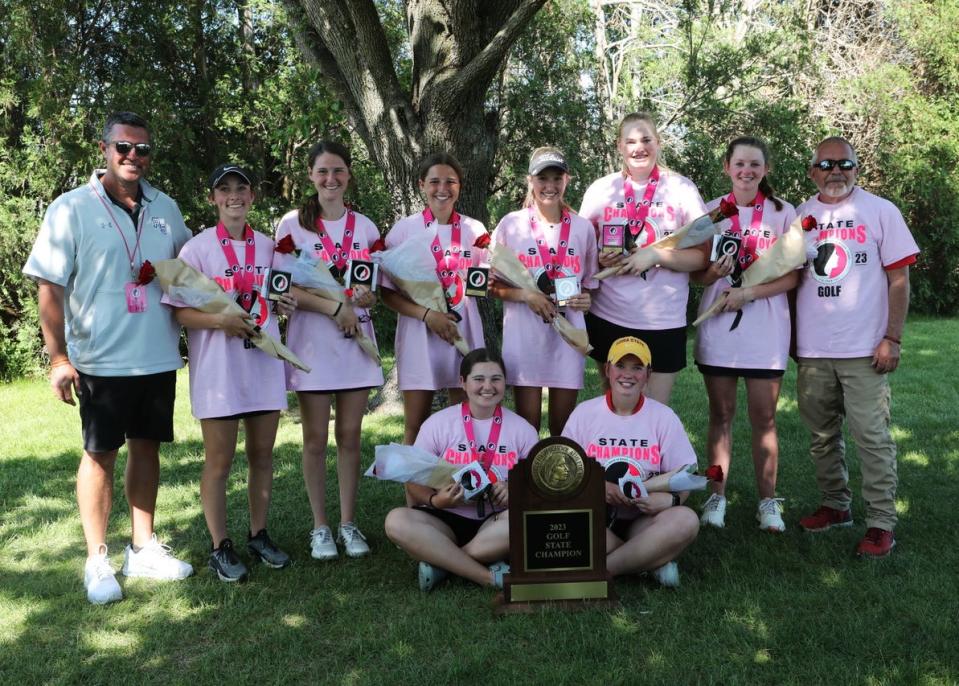 Members of the Roland-Story girls golf team pose with their Class 2A championship trophy after winning the 2A girls state golf team title Friday at the American Legion Golf Course in Marshalltown.