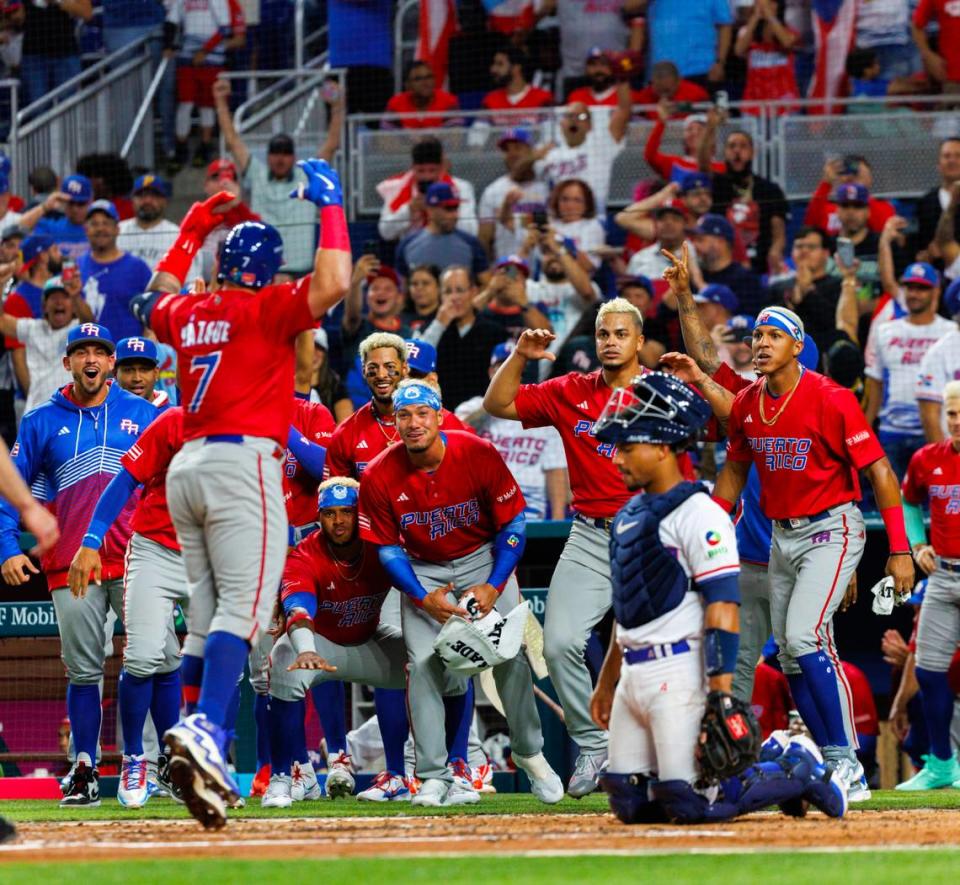 Puerto Rico designated hitter Christian Vazquez (7) celebrates with teammates after hitting on a solo home run during the third inning of a Pool D game against Dominican Republic at the World Baseball Classic at loanDepot Park on Wednesday, March 15, 2023, in Miami, Fla.