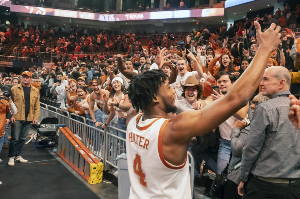 Texas guard Tyrese Hunter celebrates with the Texas student section after defeating Baylor on his shot at the buzzer following an NCAA college basketball game against Baylor, Saturday, Jan. 20, 2024, in Austin, Texas. Texas won 75-73. (AP Photo/Michael Thomas)