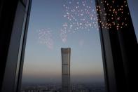 FILE PHOTO: China Zun Tower under construction is seen through a window in Beijing's central business area