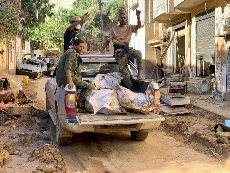 Bodies of the flooding victims are transported in Derna, Libya, Wednesday, Sept.13, 2023. Search teams are combing streets, wrecked buildings, and even the sea to look for bodies in Derna, where the collapse of two dams unleashed a massive flash flood that killed thousands of people. (AP Photo/Yousef Murad)