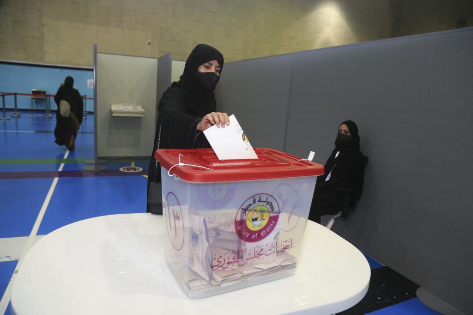 FILE - Qatari women vote in legislative elections in Doha, Qatar, Saturday, Oct. 2, 2021. The foreign fans descending on Doha for the 2022 FIFA World Cup will find a country where women work, hold public office and cruise in their supercars along the city's palm-lined corniche. (AP Photo/Hussein Sayed, File)