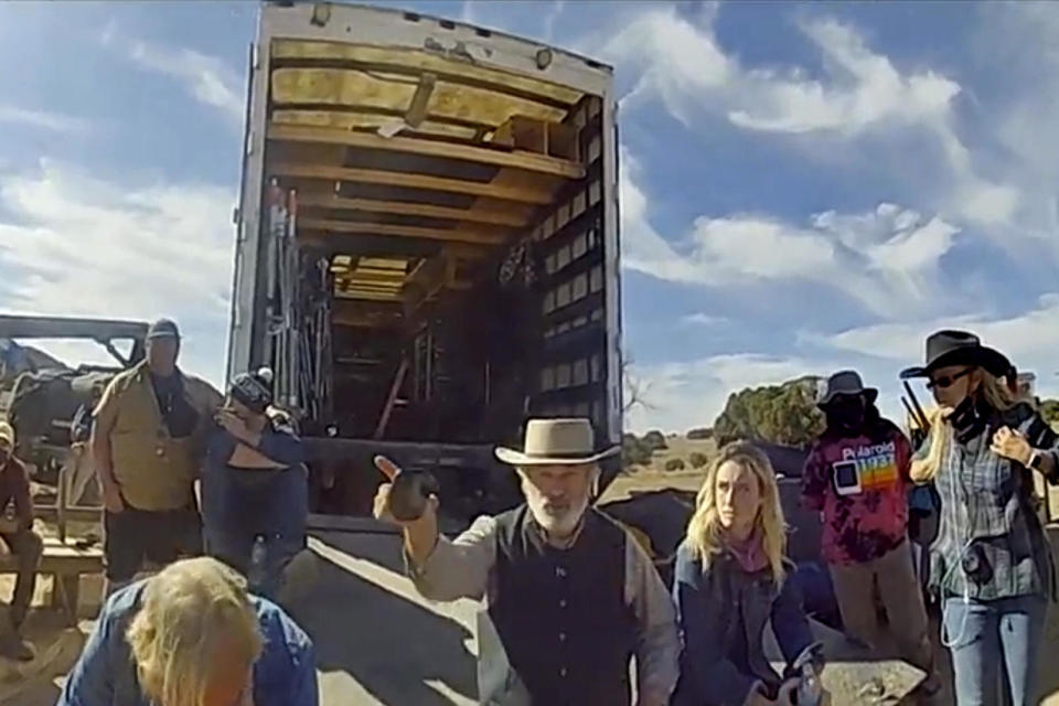 In this image taken video released by the Santa Fe County Sheriff's Office, Alec Baldwin gestures while talking with investigators following the fatal shooting on the set of 